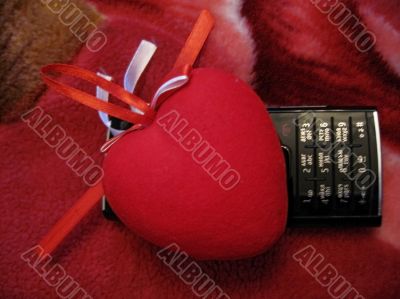 Red heart with red and white stripes and mobile phone Red heart with red and white stripes and mobile phone