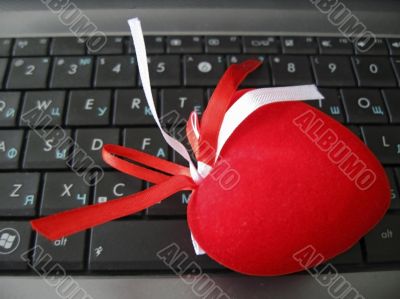 Red heart laying on the keyboard of notebook Red heart laying on the keyboard of notebook