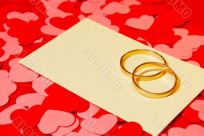 Two rings and a card with marriage proposal