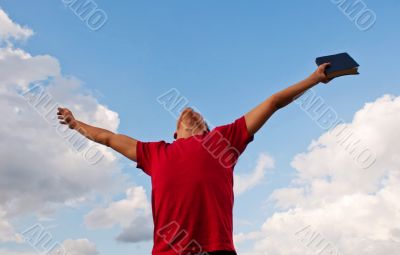 Young man staying with raised hands Young man staying with raised hands