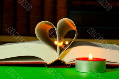 Open book with burning candle Open book with burning candle
