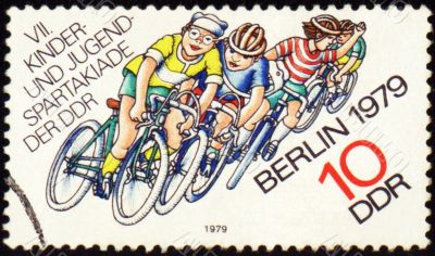 Group of young cyclists on post stamp