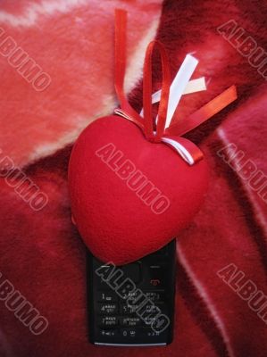 Red heart with red and white stripes and mobile phone Red heart with red and white stripes and mobile phone