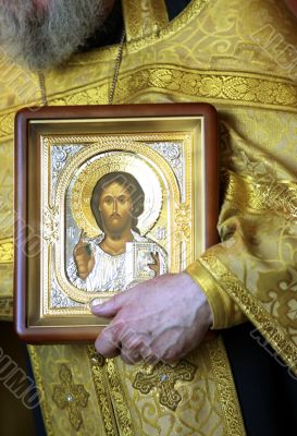 Priest with icon Jesus Christ