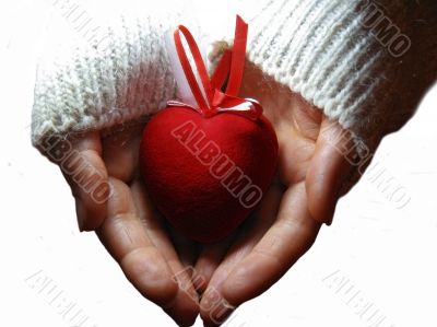 Red heart with red and white stripes on woman hands Red heart with red and white stripes on woman hands