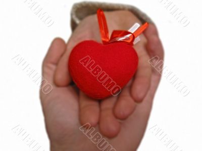 Woman hand hold a Valentine heart with a help of mans hand