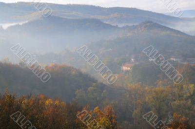 Foggy Hilly Terrain and Village