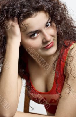 A beautiful young brunette stares into the camera