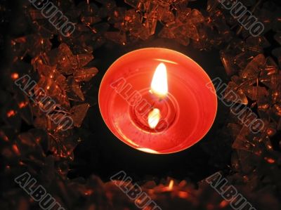 Flaming candle in basket and dark background Flaming candle in basket and dark background