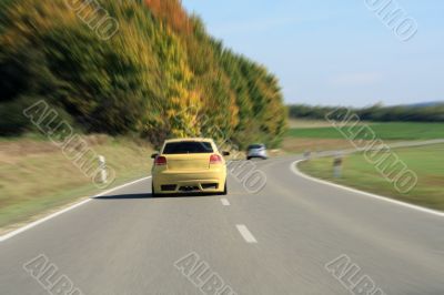 silver and yellow car driving on the road