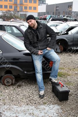 man screwed auto parts from old cars