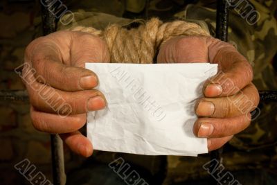 Man with hands tied up with rope