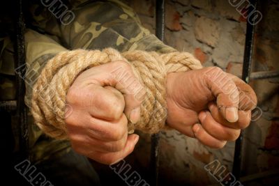 Man with hands tied with rope
