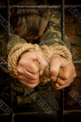Man with hands tied with rope