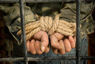 Man with hands tied up with rope Man with hands tied up with rope