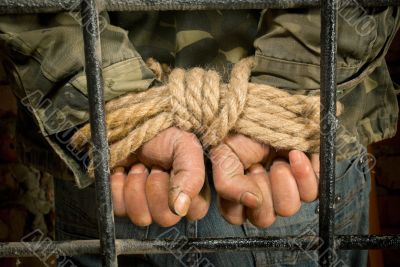 Man with hands tied up with rope