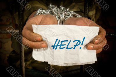 Man with hands tied with chain