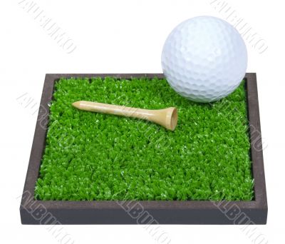 Golf Ball and Tee Laying on the Grass