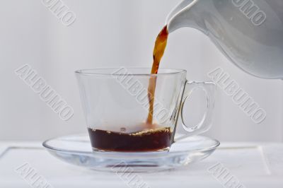 Pouring coffee into a quarter full cup