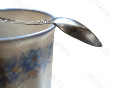 Half of cup black coffee with teaspoon over isolated Half of cup black coffee with teaspoon over isolated