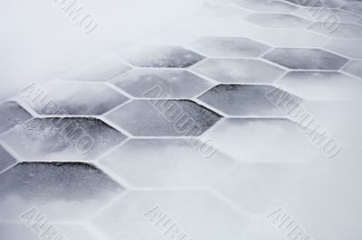 Hexagonal tiles covered with snow