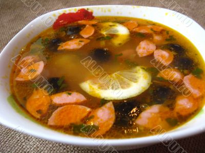 Plate with tasty soup on the grey background