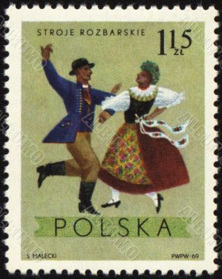 Polish folk dancers from Rozbarskie region on post stamp