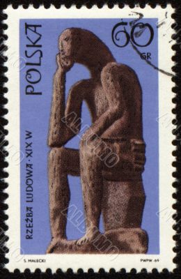 Statue of seated man on post stamp