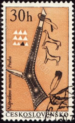 Tomahawk of American indian on post stamp