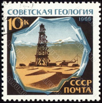 Drilling rig in desert on post stamp