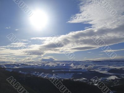 Caucasus mountains under big sun and clouds Caucasus mountains under big sun and clouds