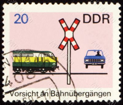 Post stamp with car on a railway crossing