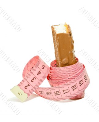 Chocolate bar with a pink metering tape Chocolate bar with a pink metering tape