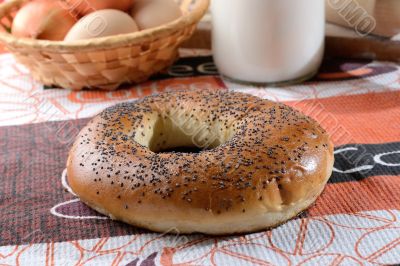 Bun on the tablecloth next to the milk Bun on the tablecloth next to the milk