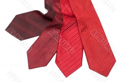 Four male ties, red and crimson