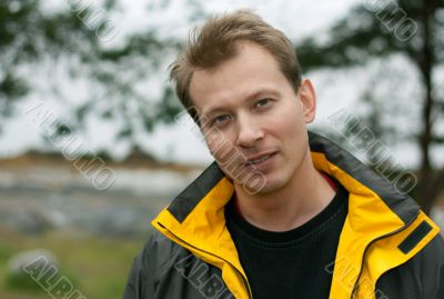 Man in yellow jacket smiles