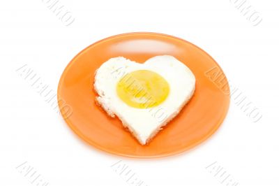Fried egg in form heart on plate