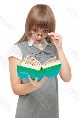 Young girl reads english and wonders