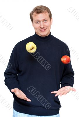 Man in dark cloth juggle apple