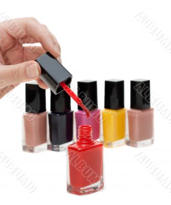 Hand with tassel and red varnish for nail