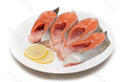 Red fish bit with lemon on plate