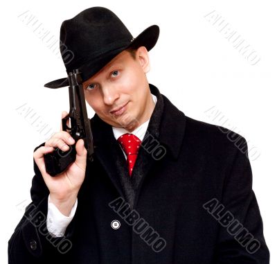 Man in suit, red tie with gun
