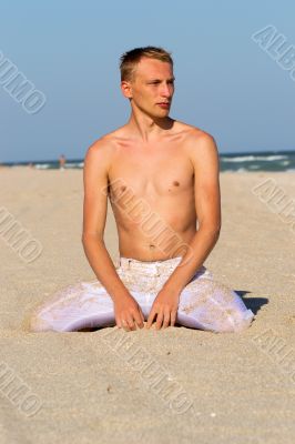 A young man in white pants