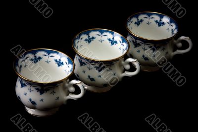 Three tea cups on saucer insulated on white background