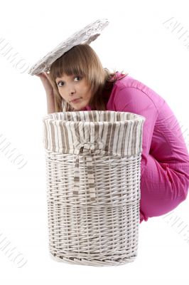 Girl peers out for baskets for linen