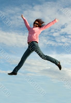 Girl in jump on background sky
