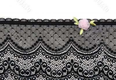 Black lace with rose satin flower on white background