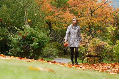 Beautiful girl goes on autumn park