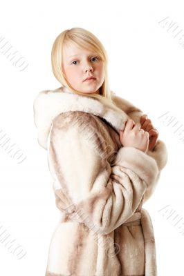 A beautiful young girl in a fur coat