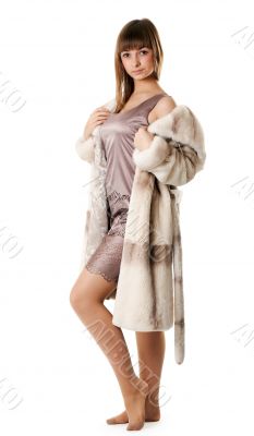 A beautiful young girl in a fur coat